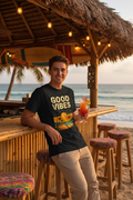 Model wearing Good Vibes t-shirt at beach bar